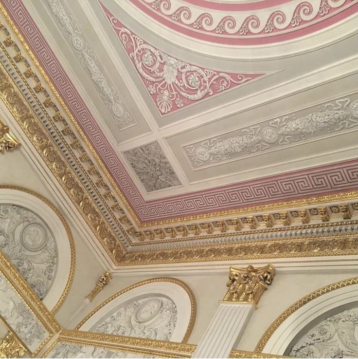 the ceiling is decorated with gold and white trimmings, which are intricately designed