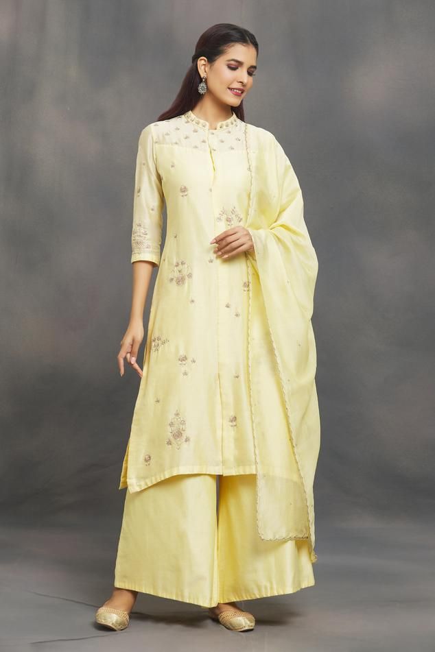 Pastel yellow kurta with aari, zardozi, sequin emboidery in floral pattern. Paired with flared pant and scallop bordered dupatta. 
Components: 3
Pattern: Embroidery
Type Of Work: Aari, zardozi, sequin, thread
Neckline: Mandarin collar
Sleeve Type: Three quarter
Fabric: Chanderi
Color: Yellow
Other Details: 
Scallop bordered dupatta
Occasion: Puja - Aza Fashions Collar Kurta, Yellow Kurta, Kurta Pant Set, Pattern Embroidery, Kurta With Pants, Pastel Yellow, Pant Set, Set For Women, Mandarin Collar