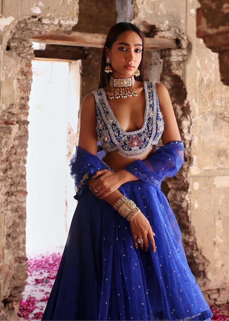 Experience the epitome of elegance with this embellished choli paired seamlessly with an embellished lehenga and dupatta. This ensemble exudes grace and sophistication, boasting intricate embellishments that captivate attention. Perfect for weddings, receptions, or any special occasion where you want to make a stunning impression. Embrace timeless beauty and elevate your style with this exquisite outfit that promises to leave a lasting impression. Unstitched Embellished Blue Sharara, Blue Embellished Georgette Lehenga, Embellished Blue Sets For Reception, Blue Embellished Georgette Anarkali Set, Embellished Blue Anarkali Pre-draped Saree, Party Wear Lehenga Shaped Like Saree For Reception, Blue Embellished Sharara For Reception, Hand Embellished Party Wear Lehenga For Eid, Elegant Blue Lehenga With Mirror Work