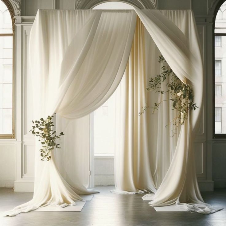 an open room with curtains and flowers on the floor