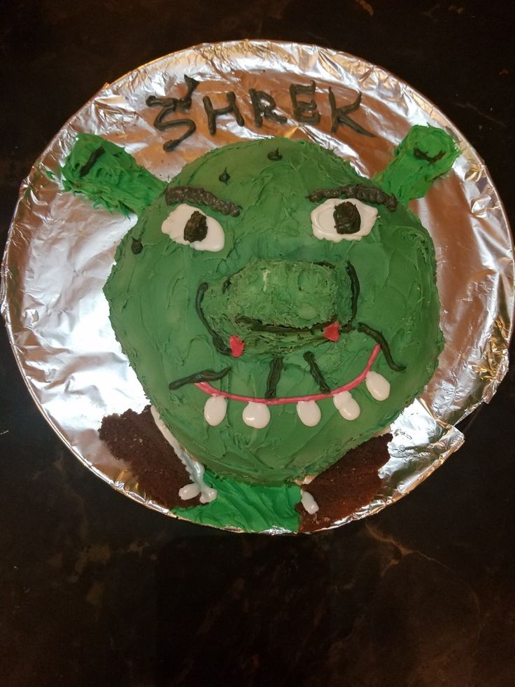 a green cake that has been decorated to look like a monster