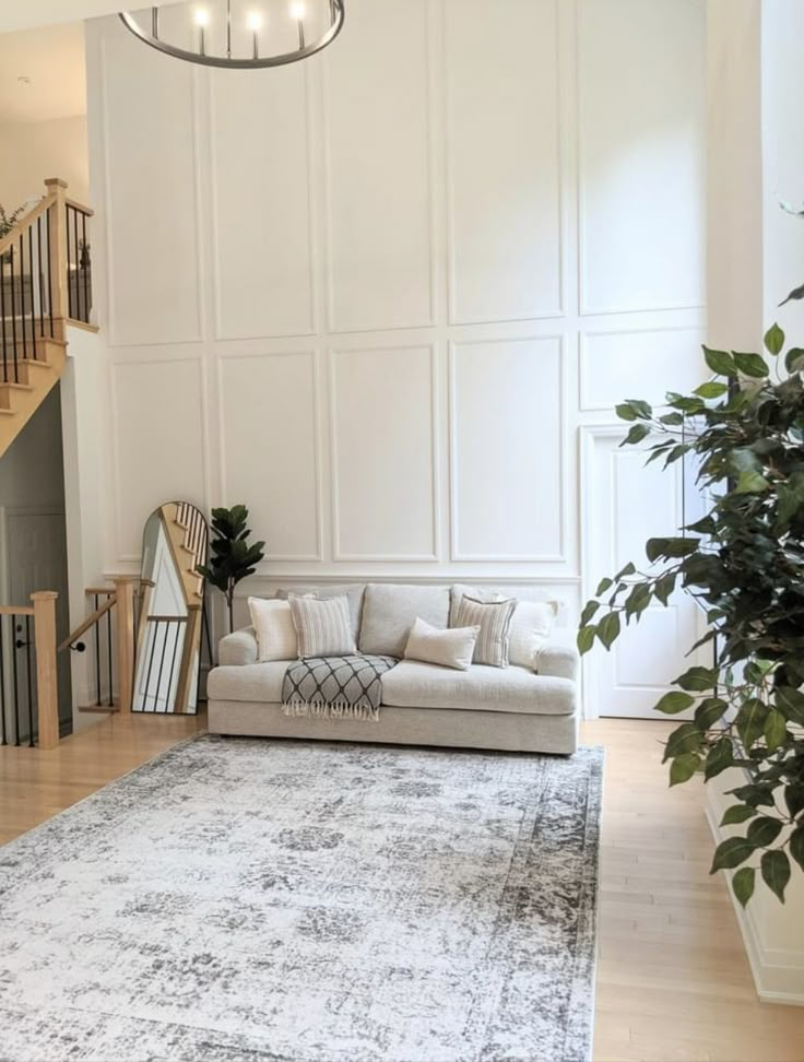 a living room filled with furniture and a large rug