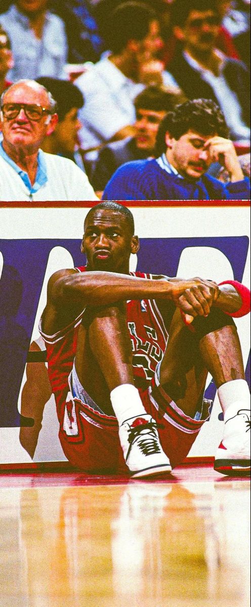 a basketball player sitting on the floor during a game