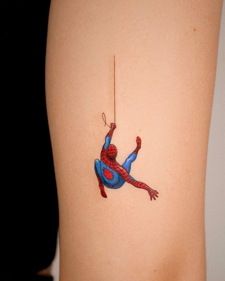 a spider - man tattoo on the back of a woman's lower body is shown