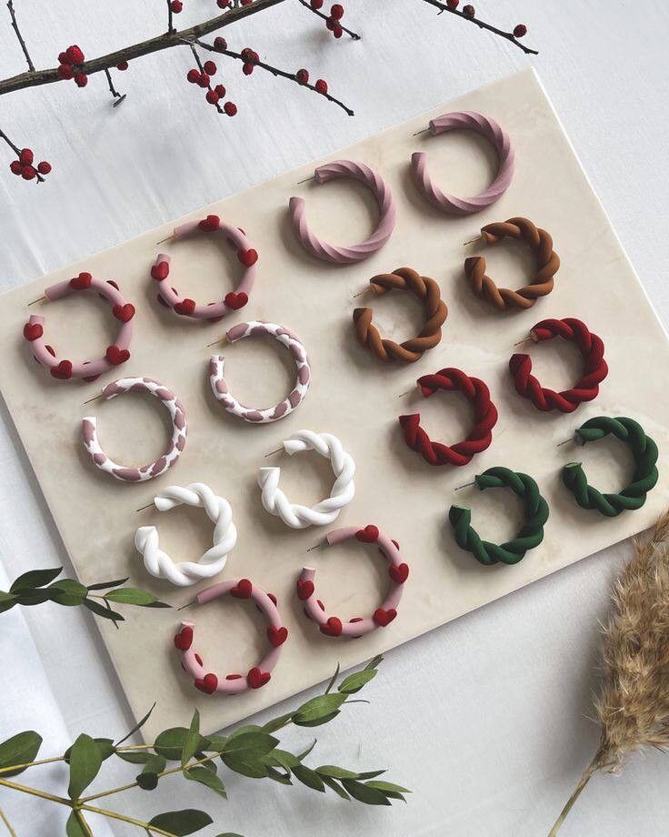 several pairs of small hair clips sitting on top of a sheet of paper next to flowers