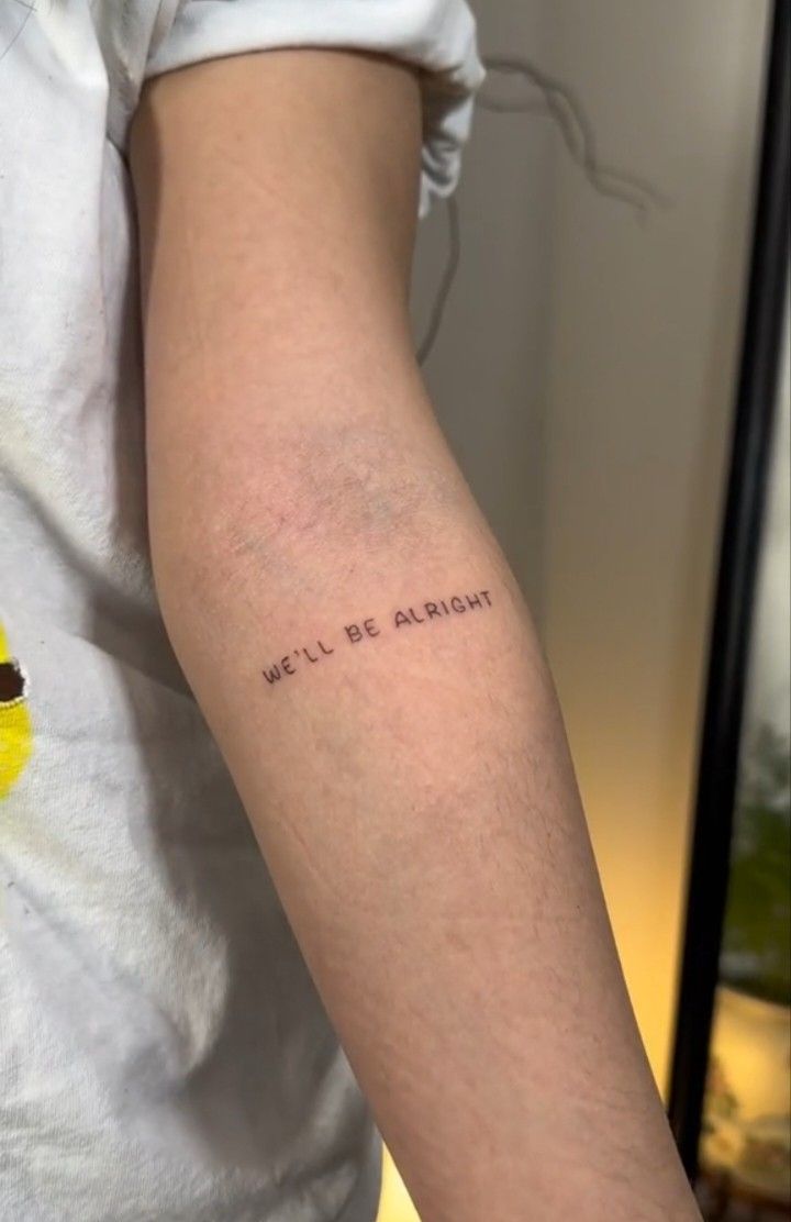 a person with a tattoo on their arm that says, we'll be alright