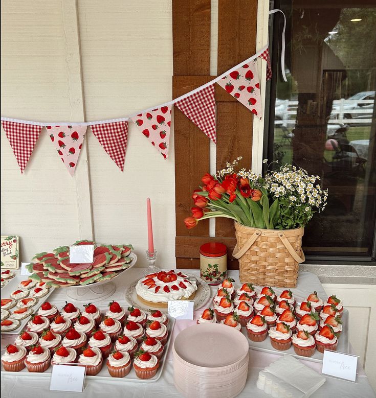 a table topped with lots of cupcakes and cakes