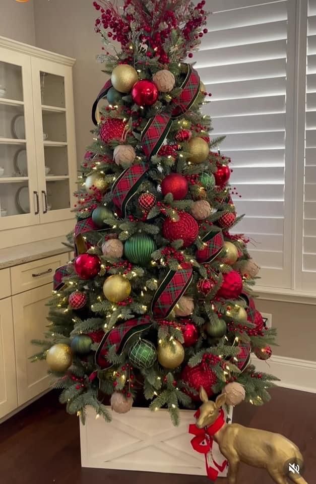 a christmas tree decorated with red, green and gold ornaments