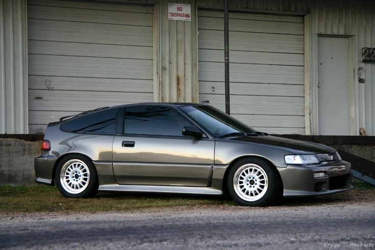 a silver car parked in front of a garage