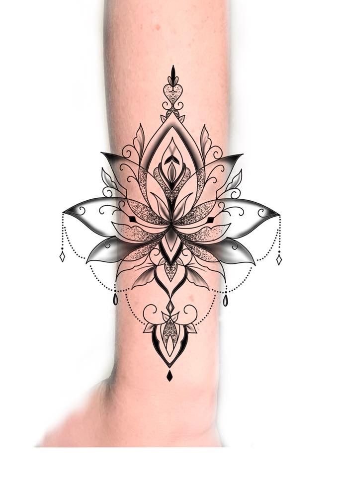 a woman's arm with a tattoo design on it