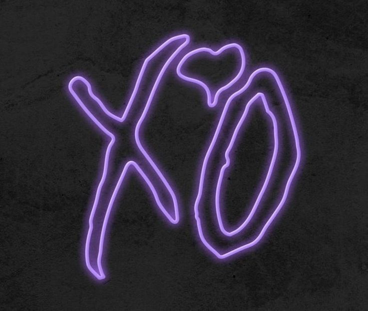 a neon sign that says xo on the side of a black wall with a pink outline