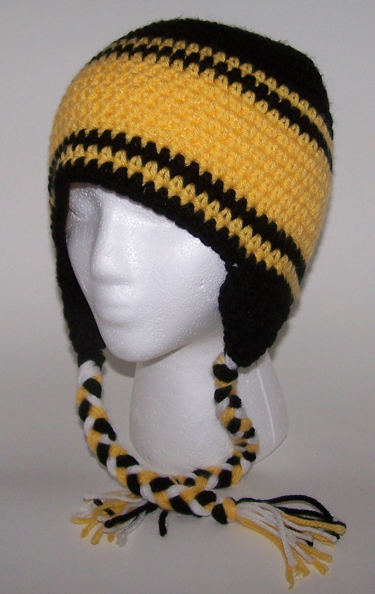 a white mannequin head wearing a yellow and black knitted beanie hat