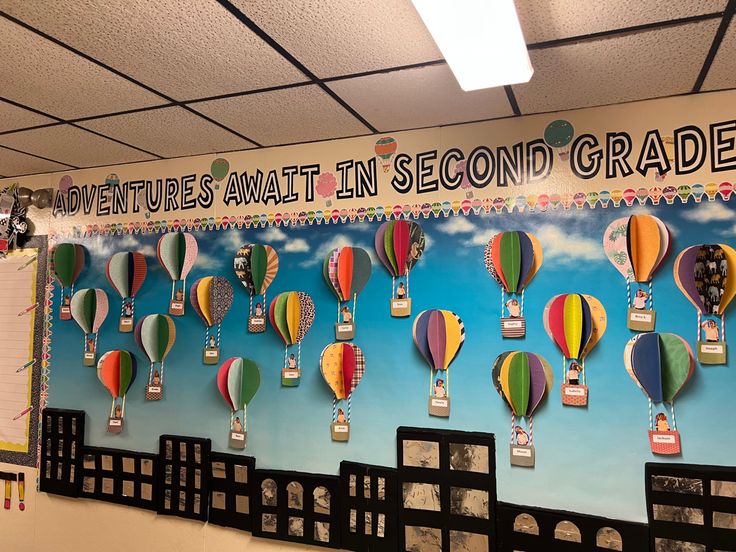 a bulletin board with hot air balloons on it and the words adventures await in second grade