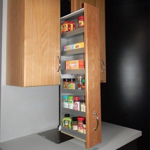 an open cabinet in the middle of a kitchen countertop with food items on it