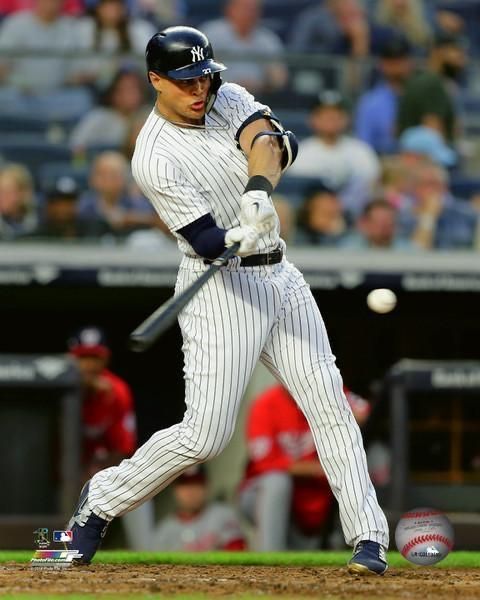 a baseball player swinging a bat at a ball