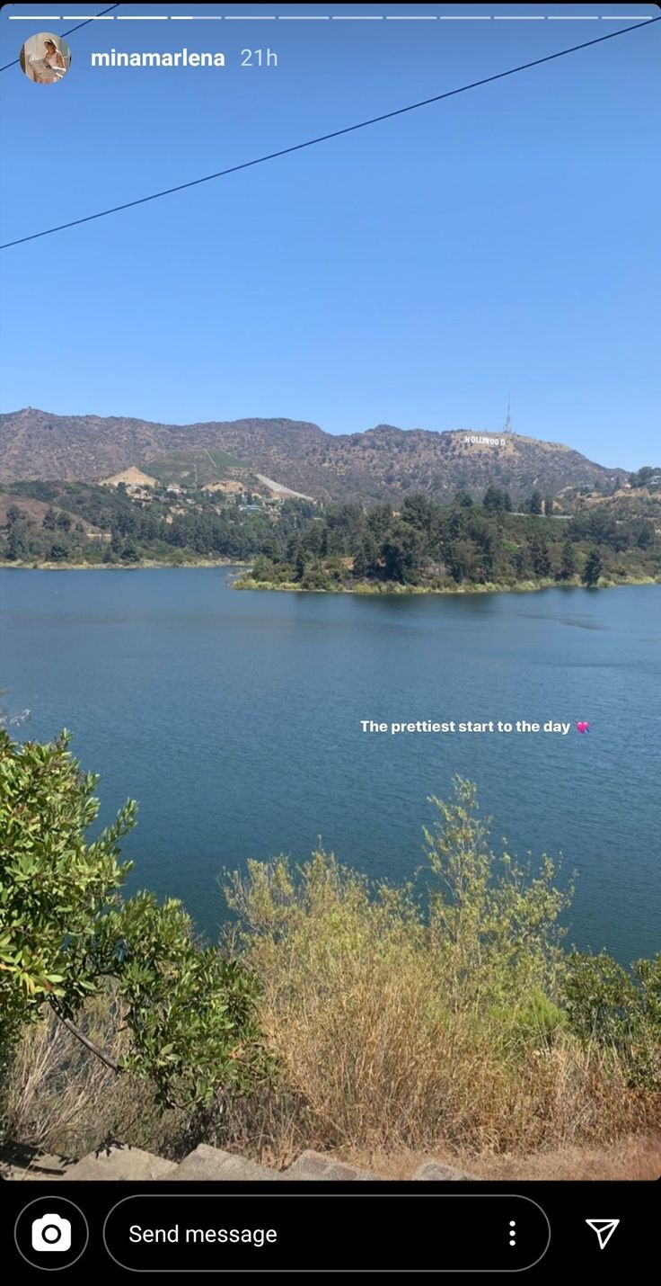 a lake surrounded by trees and hills