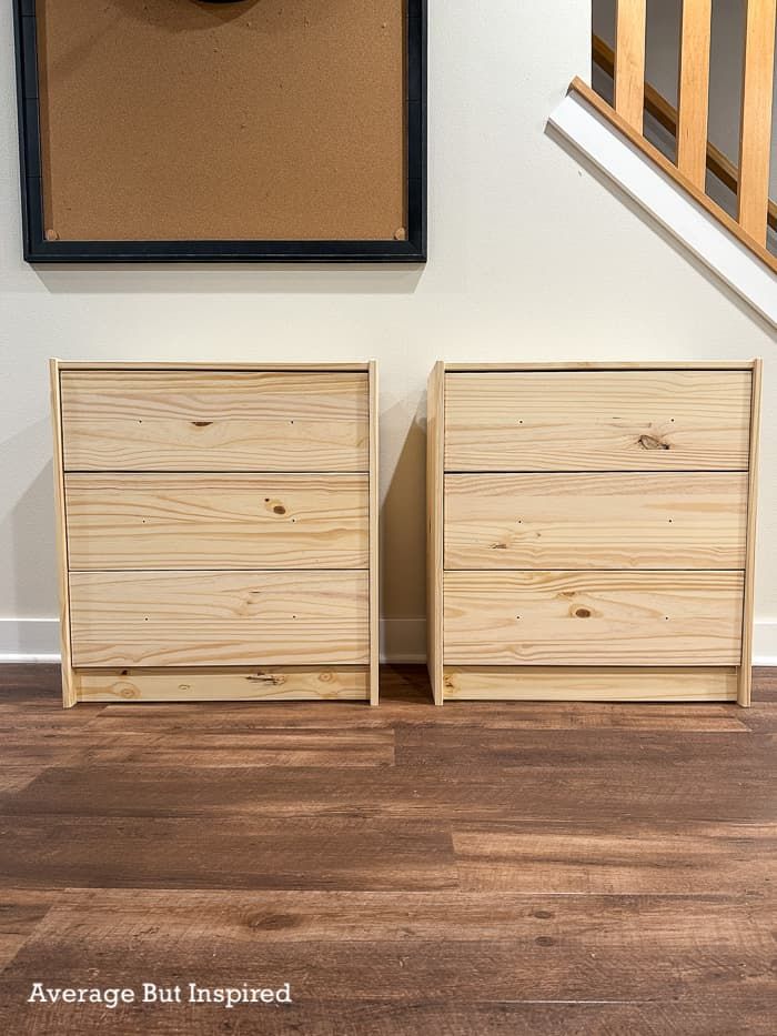 two wooden drawers sitting on top of a hard wood floor next to a stair case