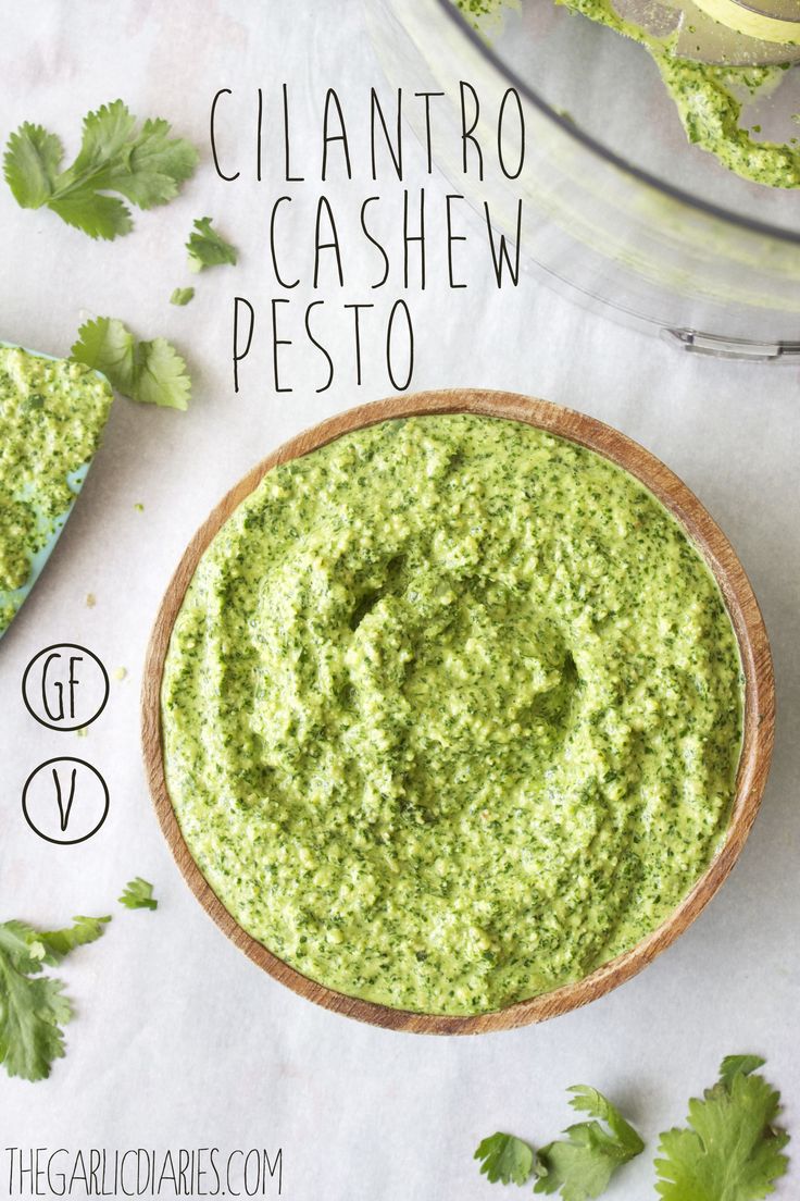 a bowl filled with cilantro cashew pesto on top of a table