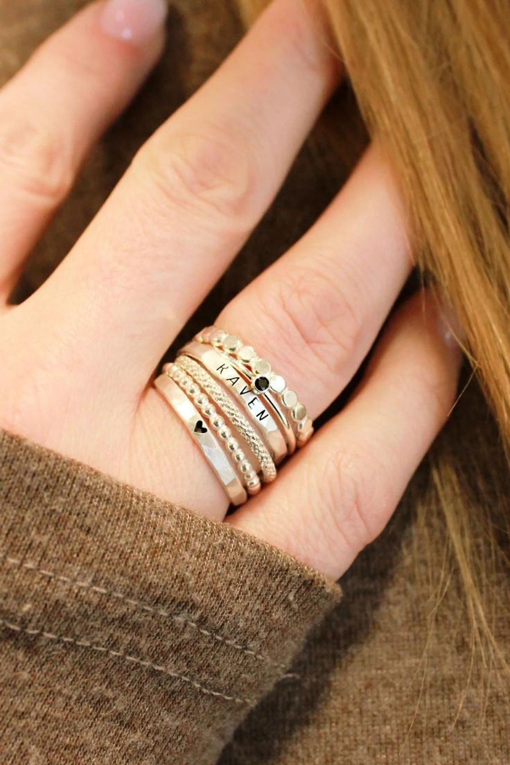 Stunning stacking name rings set, including a personalized name ring and dainty spacer rings. This silver name ring set is a great gift for mom or grandma! Discover our beautiful kids name ring stacks, the perfect sentimental gift for mom's birthday or moms-to-be! These stackable kids name rings are the perfect simple meaningful jewelry pieces to add to your collection. Shop all of our custom personalized jewelry and silver name rings here! Elegant Sterling Silver Stackable Initial Ring, Sterling Silver Stackable Initial Ring, Silver 14k Gold Stackable Initial Ring, Elegant Stackable Sterling Silver Birthstone Ring, Dainty White Gold Stackable Engraved Ring, Dainty Personalized Silver Heart Ring, Sterling Silver Stackable Initial Ring For Wedding, Personalized Silver Heart Ring In 14k Gold, Wedding Sterling Silver Stackable Initial Ring