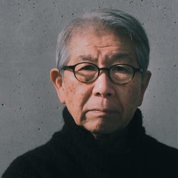 an old man with glasses is looking at the camera while wearing a black turtle neck sweater