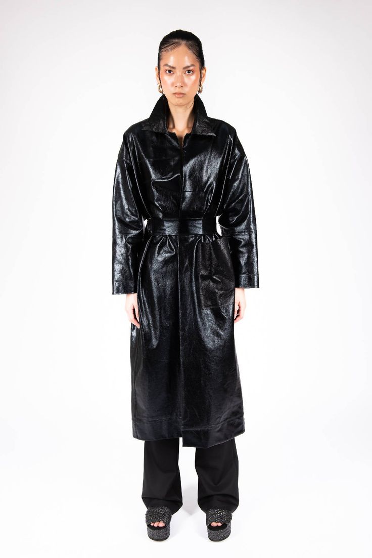 The unlined construction of ADIAMELIAS black coat is lightweight with contemporary sophistication. It’s crafted from single faced shiny matted cotton thats perfect for spring, then is finished to a longline silhouette with narrow lapels, patch pocket and a detachable belt. The coat has patch work through out the body with gives it a contemprary retro look. Sleek Black Belted Outerwear, Sleek Outerwear With Belted Cuffs And Long Sleeves, Sleek Long Sleeve Outerwear With Belted Cuffs, Modern Black Outerwear With Belted Cuffs, Long Black Coat, Patch Work, Retro Look, Long A Line, Long Coat