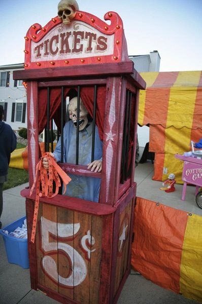 a man in a red and yellow ticket booth