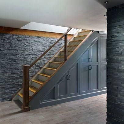 an empty room with stone walls and stairs