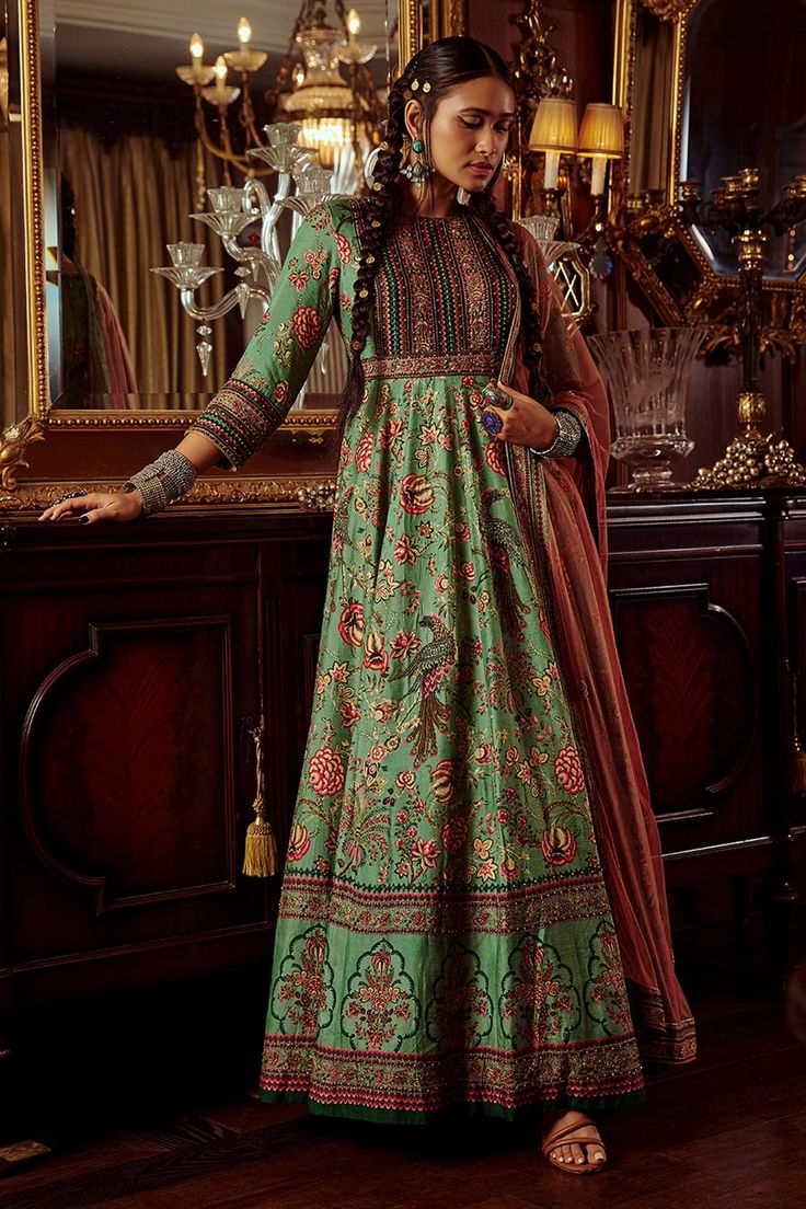 Sea green hand painted and printed anarkali with embroidered detail. Paired with an sheer dupatta.
Component: 2
Pattern: Hand painted, Printed, Embroidered
Type Of Work: Floral motifs, Thread work
Neckline: High neck
Sleeve Type: Three quarter
Fabric: Viscose silk, Net
Color: Green
Other Details: 
Contrast dupatta
Note: Yellow anarkali set worn by the other model is not for sale
Occasion: Reception - Aza Fashions Hijabi Art, Yellow Peacock, Yellow Anarkali, Anarkali With Dupatta, Green Anarkali, Fashion Layering, Ridhi Mehra, Applied Psychology, Traditional Attires