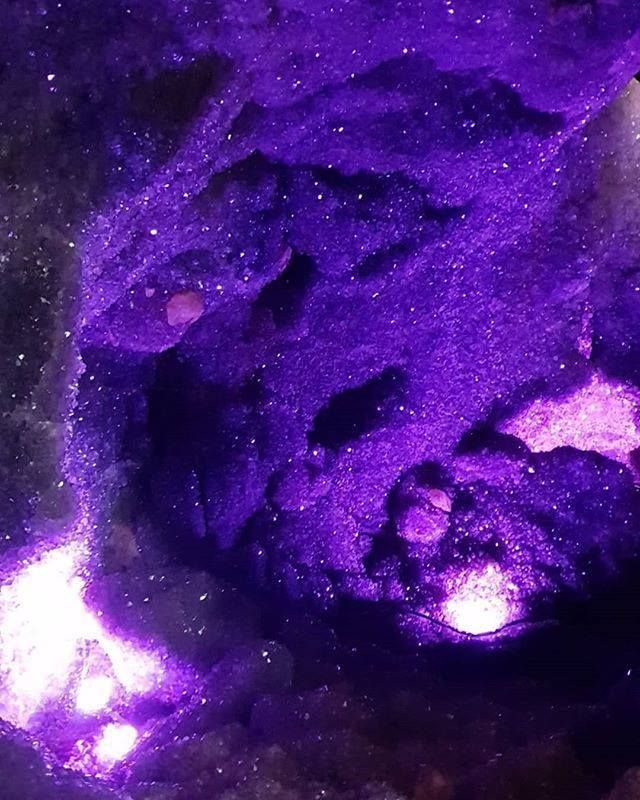 a purple rock in the middle of some rocks