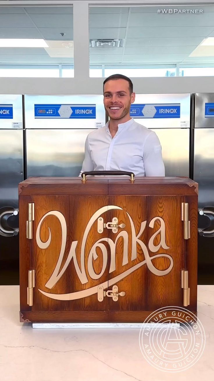 a man standing behind a wooden box with the word honka on it's side