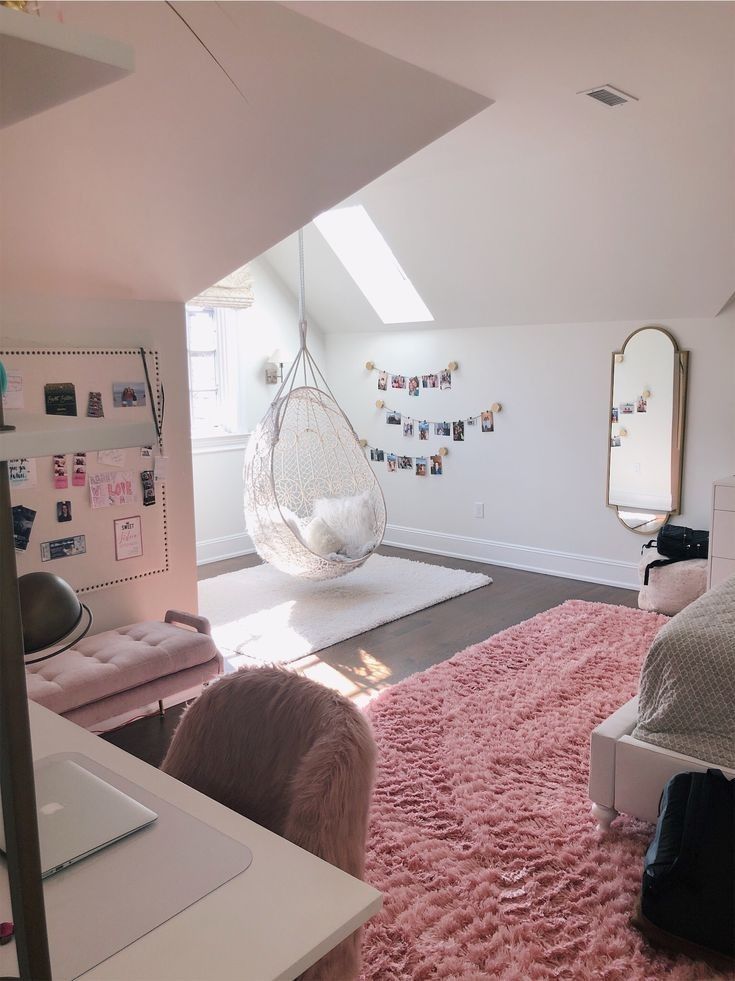 a bedroom with a hammock hanging from the ceiling and pink rug on the floor