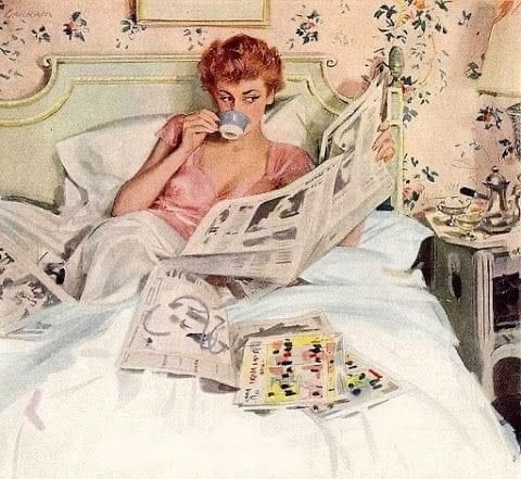 a woman laying in bed reading a newspaper and drinking from a cup with a teapot