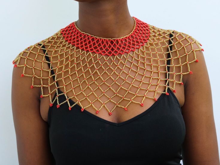 African Beaded cape necklaces, Beaded wedding necklace, Beaded shawl necklaces, Statement necklace, Christmas gift for her, Tribal necklace A 100% handmade in Kenya necklace. Can fit any body type as it layers well with the body *Color: Gold and Red *Necklace height:  8 inch/20 cm *Neck size length : 13.5 inch / 34 cm (Adjustable and extends up to 16 inch/ 41cm 3-5 days delivery via shipping via DHL Express  Shipping fee is for the first item only and additional items ship for free. To continue Red Jewelry With Bead Caps, Red Beaded Chain Necklace For Wedding, Gold Bib Necklace With Large Beads As Gift, Gold Bib Necklace With Large Beads For Gift, Gold Beaded Necklaces With Bead Caps For Gift, Gift Gold Beaded Necklaces With Bead Caps, Beaded Bridal Necklace Gift, Elegant Red Beaded Bib Necklace, Gold Beads Bib Necklace Gift