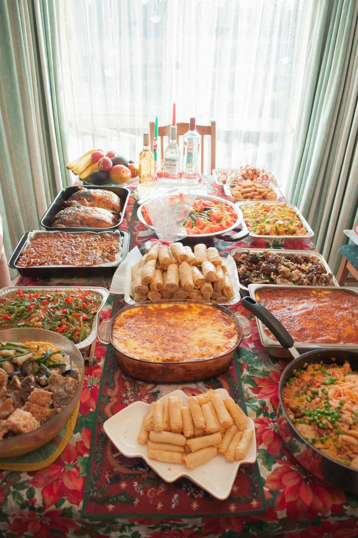 a table filled with lots of different types of food on top of plates and pans