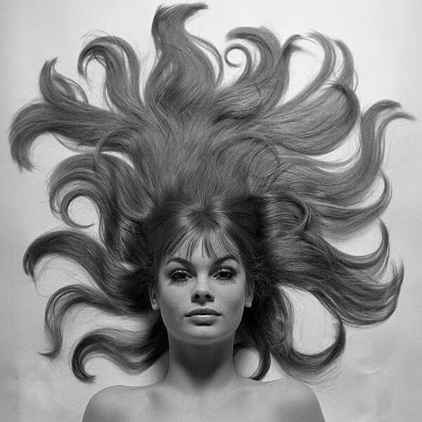 a woman with her hair blowing in the wind