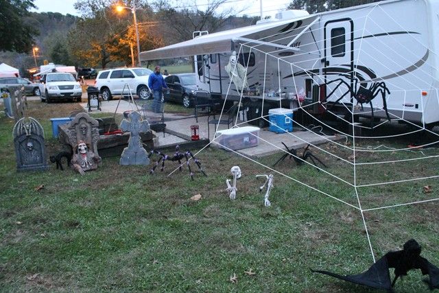 an rv is parked in the grass with halloween decorations