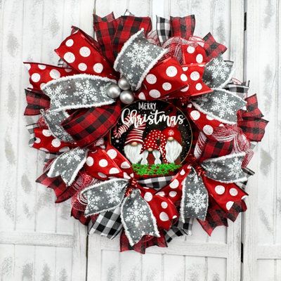 a red and white christmas wreath with snowflakes