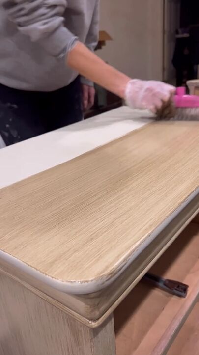 a person in white gloves is cleaning a table