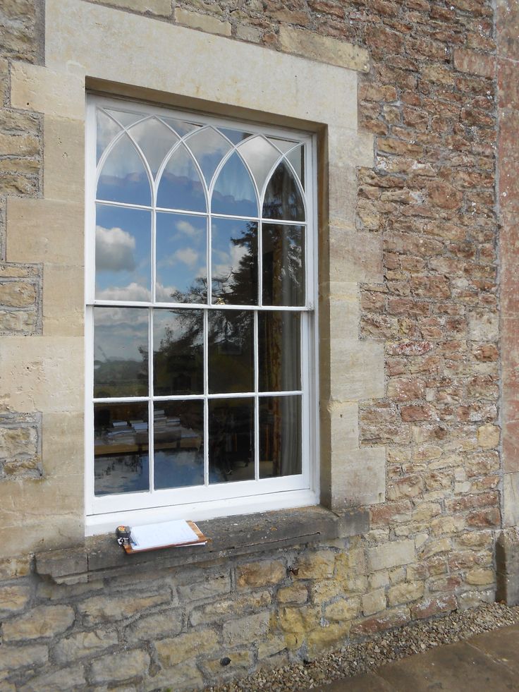 an old stone building with a large arched window