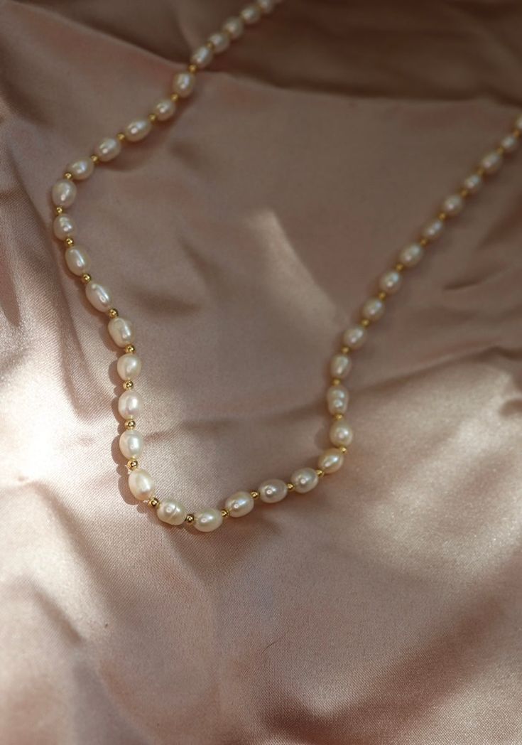 The Marylin pearl necklace is a beautiful pearl necklace with gold filled accents. The Marylin necklace is made of delicate freshwater pearl, and can be worn in remembering that without grit, there is no pearl. Wear this necklace as a symbol of your dedication and hard work in getting to where you are today. Beautiful piece to wear individually or layered! Necklace: 24K Gold Filled spacers and Freshwater Pearls 6mm x 4mm Length: 16” inches White Single Strand Pearl Necklace With 14k Gold Filled, Gold Pearl Pendant Necklace In 14k Gold Filled, Classic Gold Beaded Necklace With Pearl Pendant, Gold Single Strand Dainty Pearl Necklace, Dainty Single Strand Akoya Pearl Necklace, Dainty Akoya Pearl Single Strand Necklace, Gold Beaded Akoya Pearl Necklace With Pearl Chain, Gold Akoya Pearl Beaded Necklace With Pearl Chain, Gold Akoya Pearl Chain Beaded Necklace