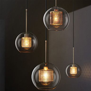 three lights hanging from the ceiling in a room with black walls and flooring, one is