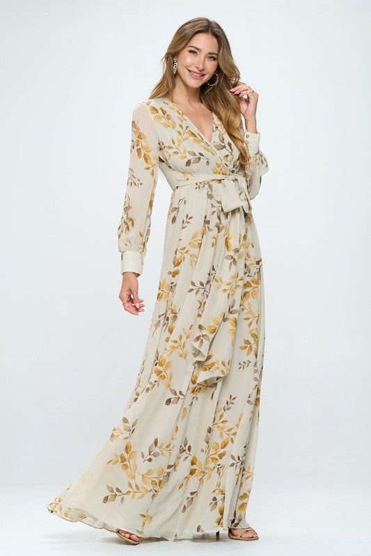 Introducing our stunning floral maxi dress. This dress features beautiful bubble sleeves and a flattering v-neckline, as well as a wrapped waist tie detail that helps create a stunning silhouette. The metallic threads and gold button details add an extra touch of glamour to this already stunning dress. The body of the dress is fully lined, ensuring both comfort and modesty, while the see-through sleeves add an elegant touch. The elastic waistband makes this dress perfect for expectant mothers, a White Floral Print Maternity Maxi Dress, Feminine Floral Print Maternity Maxi Dress, Bohemian Floral Print Maternity Maxi Dress, Fitted Maternity Dress With Floral Print And V-neck, Maternity V-neck Maxi Dress With Floral Print, Modest Tops, Gold Buttons, Floral Maxi, Metallic Thread