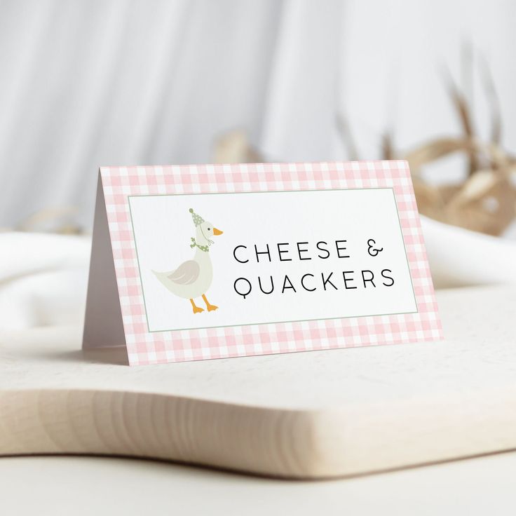 a place card sitting on top of a cutting board with deer antlers in the background