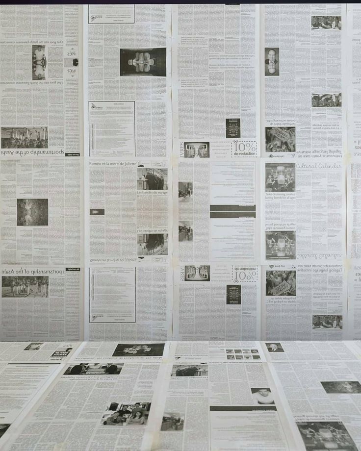 several newspapers spread out on top of each other in front of a black and white background