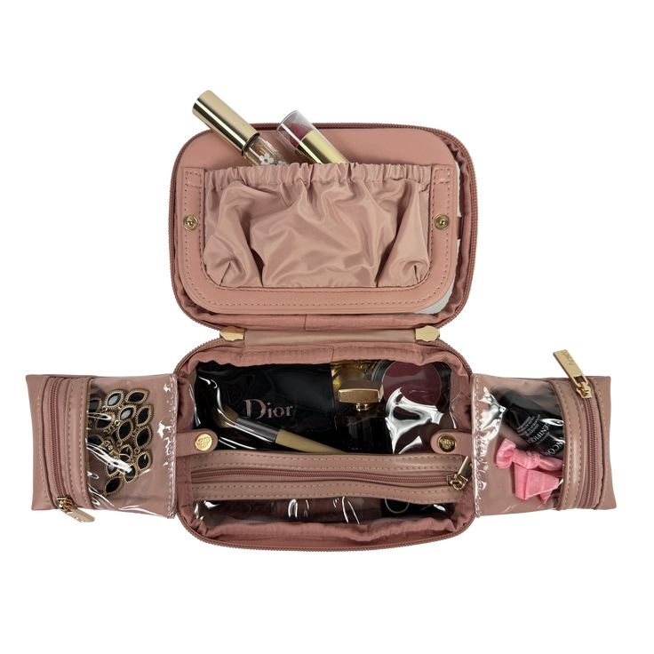 the inside of a pink travel bag filled with makeup and other items on a white background