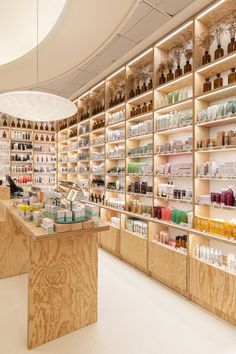 the inside of a store filled with lots of bottles and shelves full of goods on display