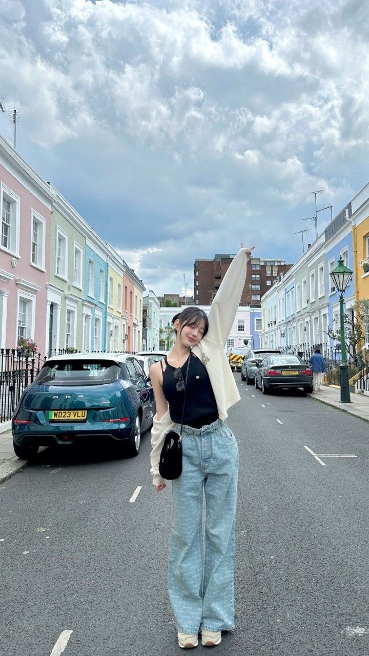 a woman standing in the middle of a street