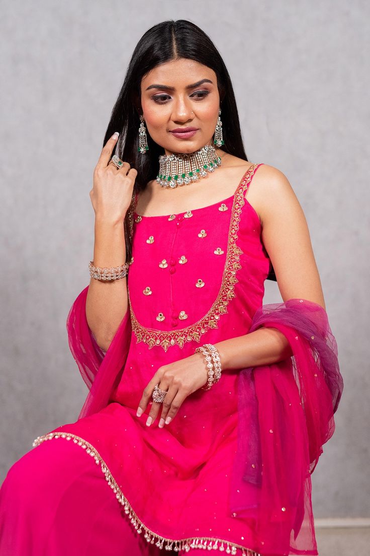 Hot pink embroidered strappy kurta with mirror and gota detail. Paired with solid sharara and dupatta.
Component: 3
Pattern: Hand embroidered
Type Of Work: Sequin work, Nalki work, Mirror work, Mukaish work
Neckline: Square
Sleeve Type: Sleeveless
Fabric: Organza, Georgette, Net
Color: Pink
Other Details: 
Ombre dupatta
Occasion: Reception,Wedding - Aza Fashions Strappy Kurta, Ombre Dupatta, Mukaish Work, Kurta Sharara Set, Kurta Sharara, Sharara Set, Reception Wedding, Mirror Work, Pink Sequin