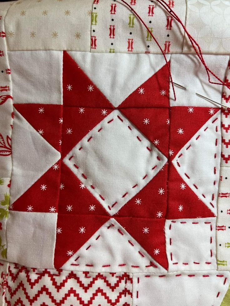 a red and white patchwork quilt on a table