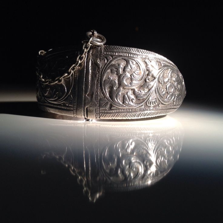 "Spectacular acanthus repousse with geometric borders. Weight is about 96 grams. A handsome example of the craftsmanship of the Indian silversmith during the time of the Raj. Condition is excellent with the heavy patina, wear, and minor dents that I like to see in an antique tribal piece. This bracelet has a small key which is inserted into an open hinge and turned to secure it. The open hinge has an iron pin (probably for strength). Dimensions: 6.75\" in circumference. No bigger wrist will fit. Antique Silver Oxidized Metal Cuff Bracelet, Antique Silver Oxidized Cuff Bracelet, Adjustable Antique Silver Traditional Cuff Bracelet, Luxury Traditional Oxidized Sterling Silver Bracelet, Ornate Oxidized Silver Bracelet, Geometric Borders, Fashion Trend Inspiration, Cufflinks Men, Belt Buckles